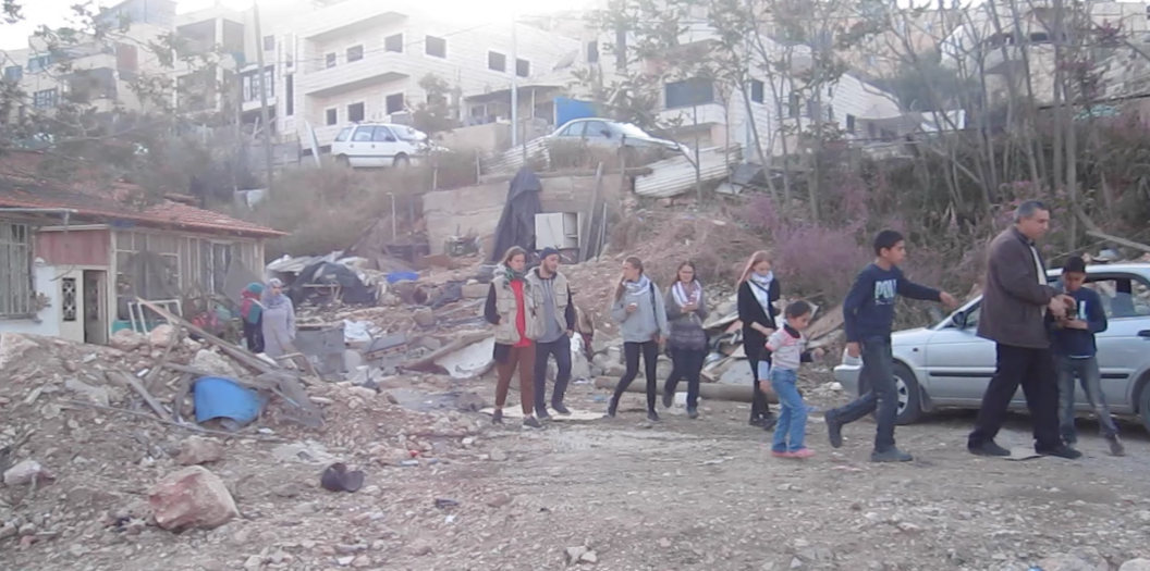 Nureddin Amro showing his partially demolished home.